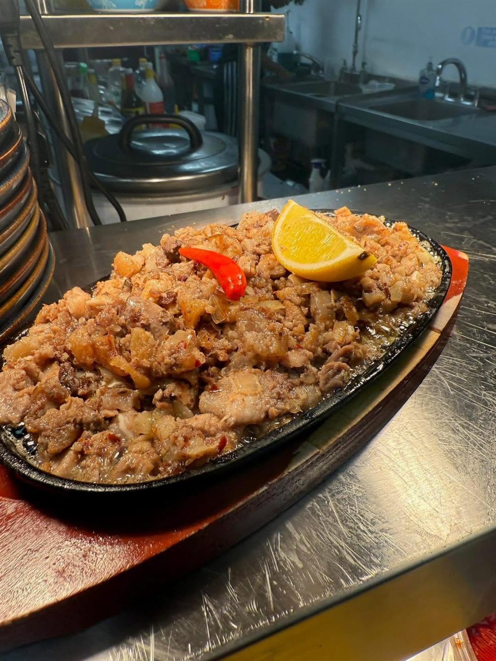 Kapampangan sisig on a sizzling plate