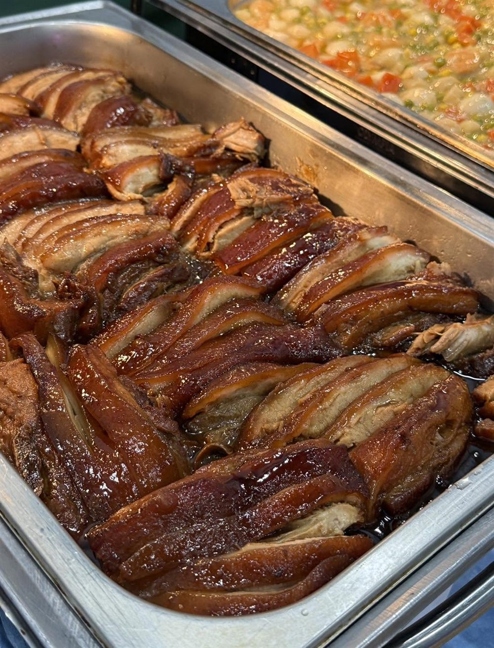 A catering tray of roast pork